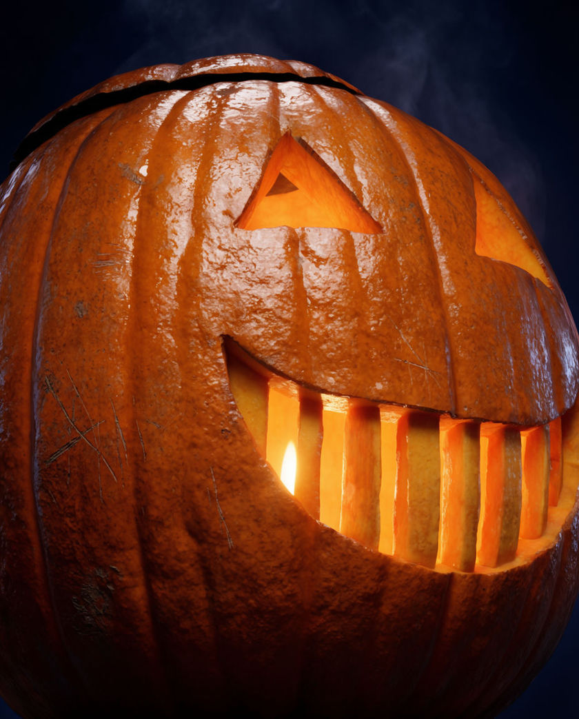 A carved pumpkin lit from inside filling the frame, warm light spilling out through the cut eyes across the ridged rind