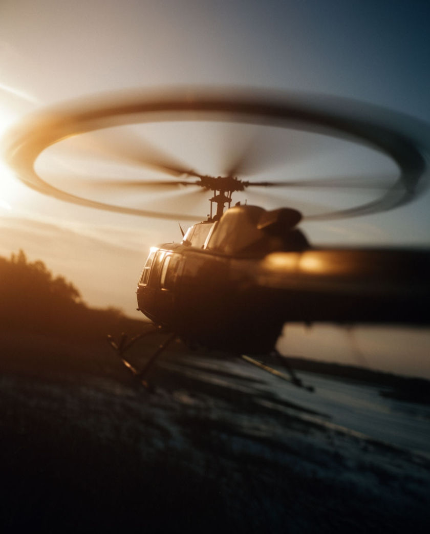 A rotor disc blurred into a single ring above a fuselage, blades cropped by the frame on both sides