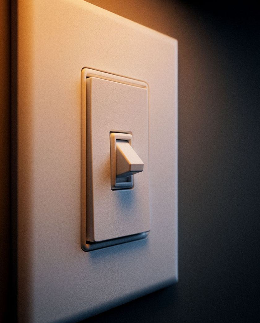 A finger pressing a white wall switch caught the instant of the flick under warm low side light against a dark ground