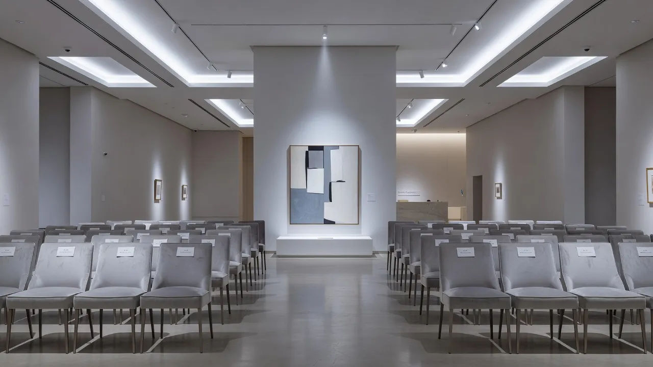 Art auction house with a lot under a spotlight