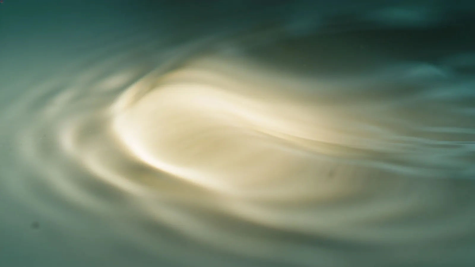 Soft teal-and-cream waveform rippling on pale surface