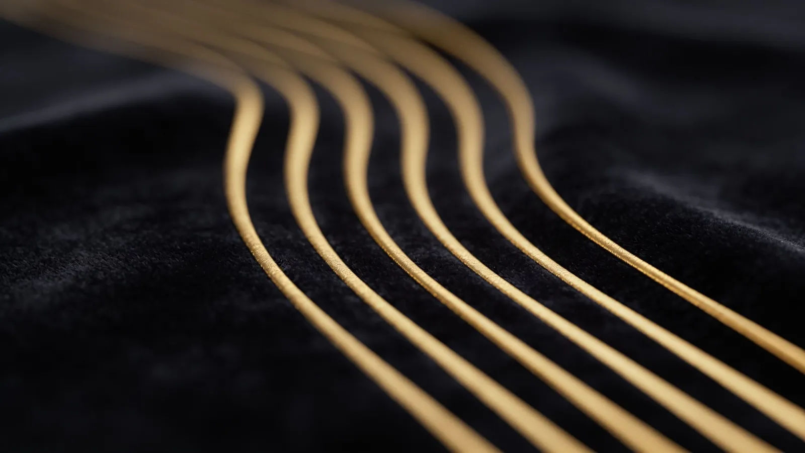 Smooth gold waveform on dark velvet ground