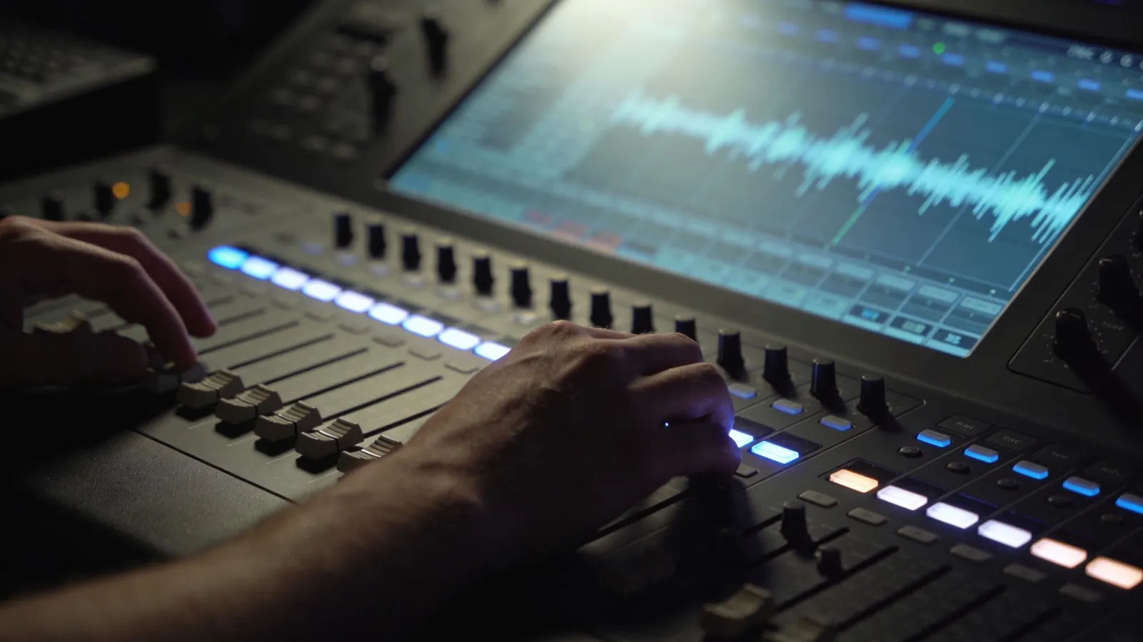 Hands hesitating over backlit console with jittery waveform