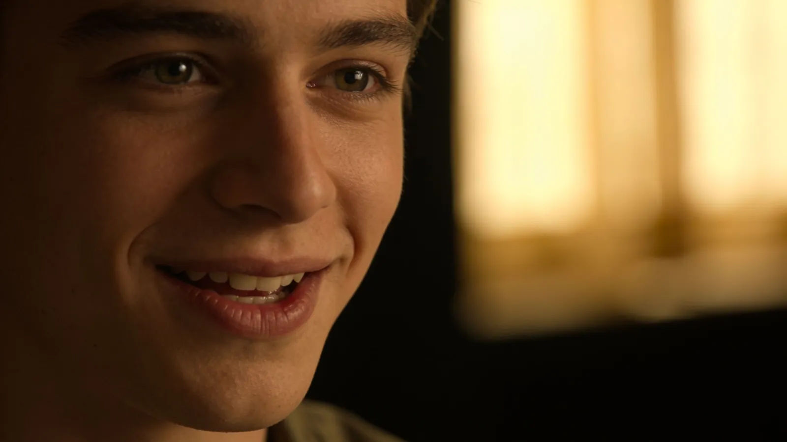 Warm smiling young man portrait mid-speaking