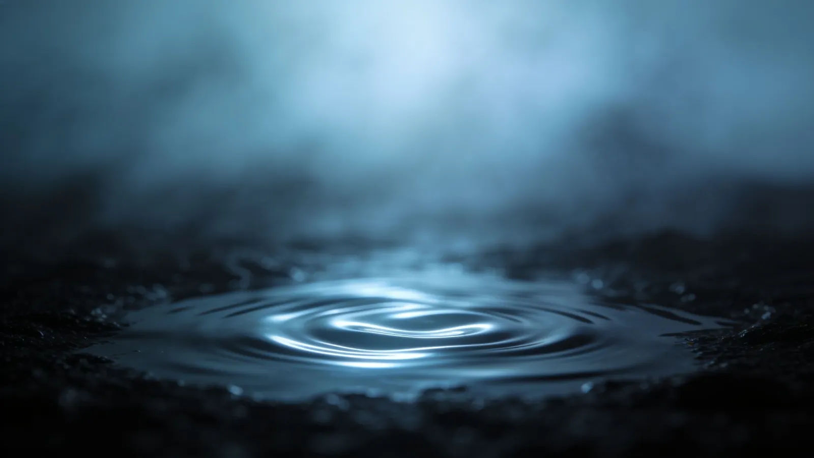 Gentle glowing ripples across dark still water