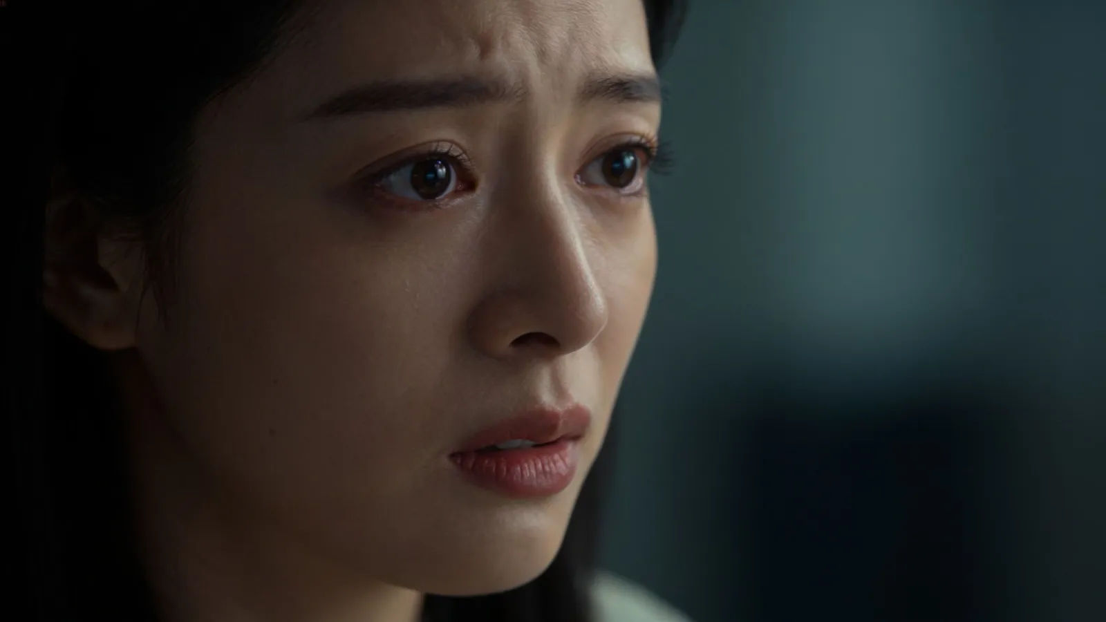 Worried person, soft strained expression, moody light
