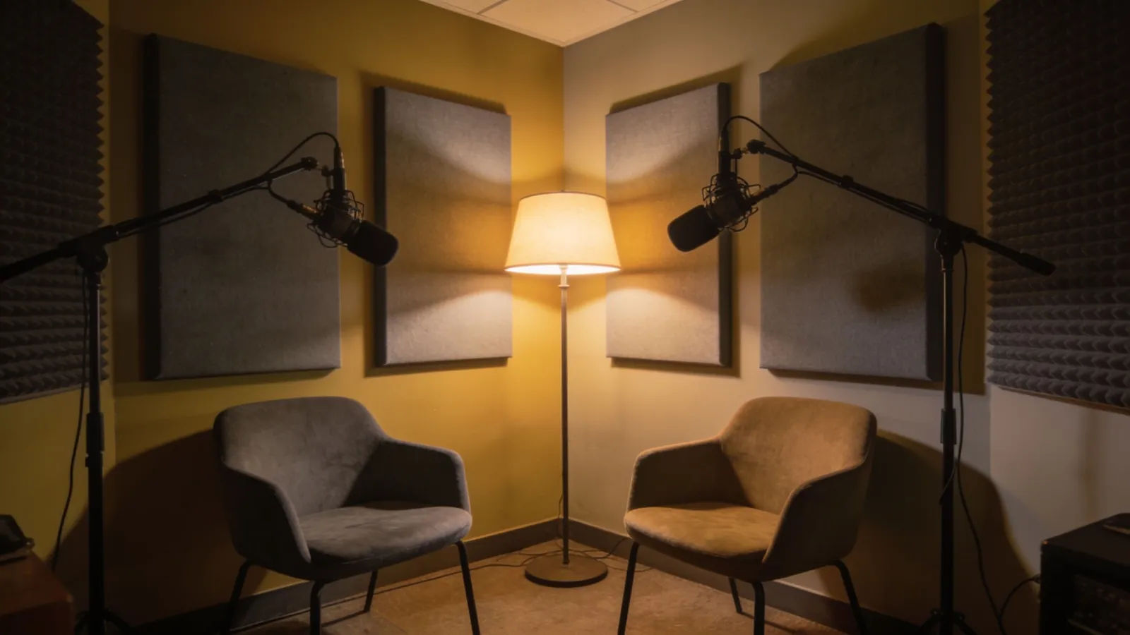 Cozy podcast corner, two empty chairs, warm lamps