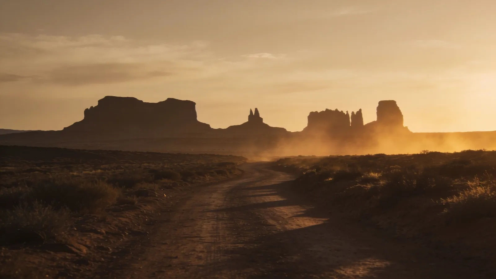 Wide desert frontier trail at dusty dusk