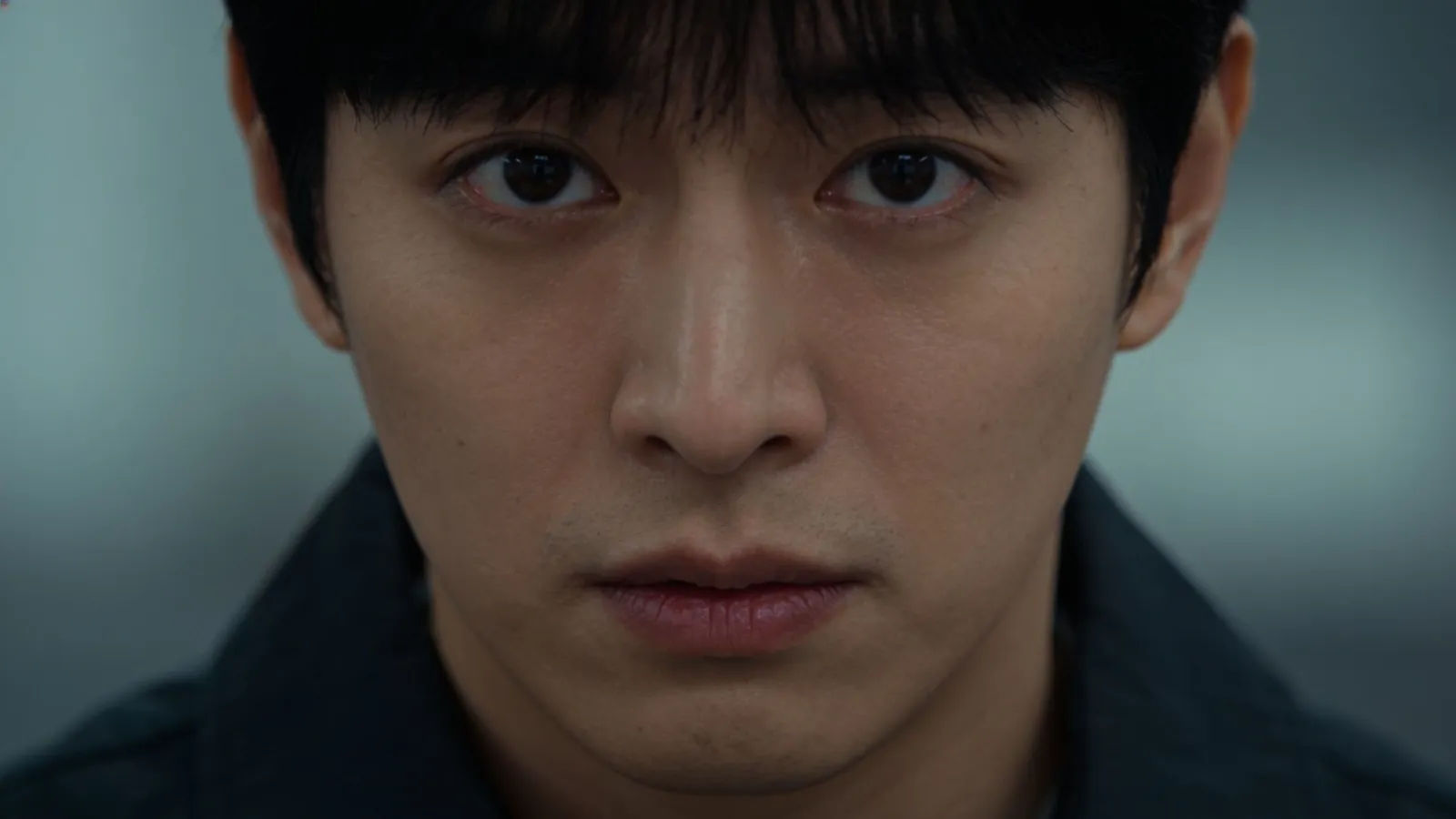 Expressionless deadpan performer in cinematic portrait