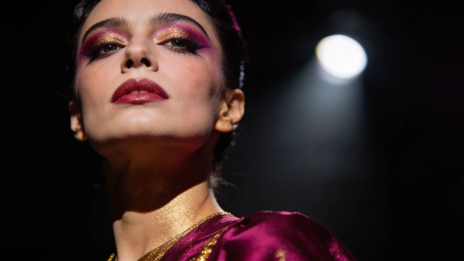 Glamorous theatrical performer under a spotlight