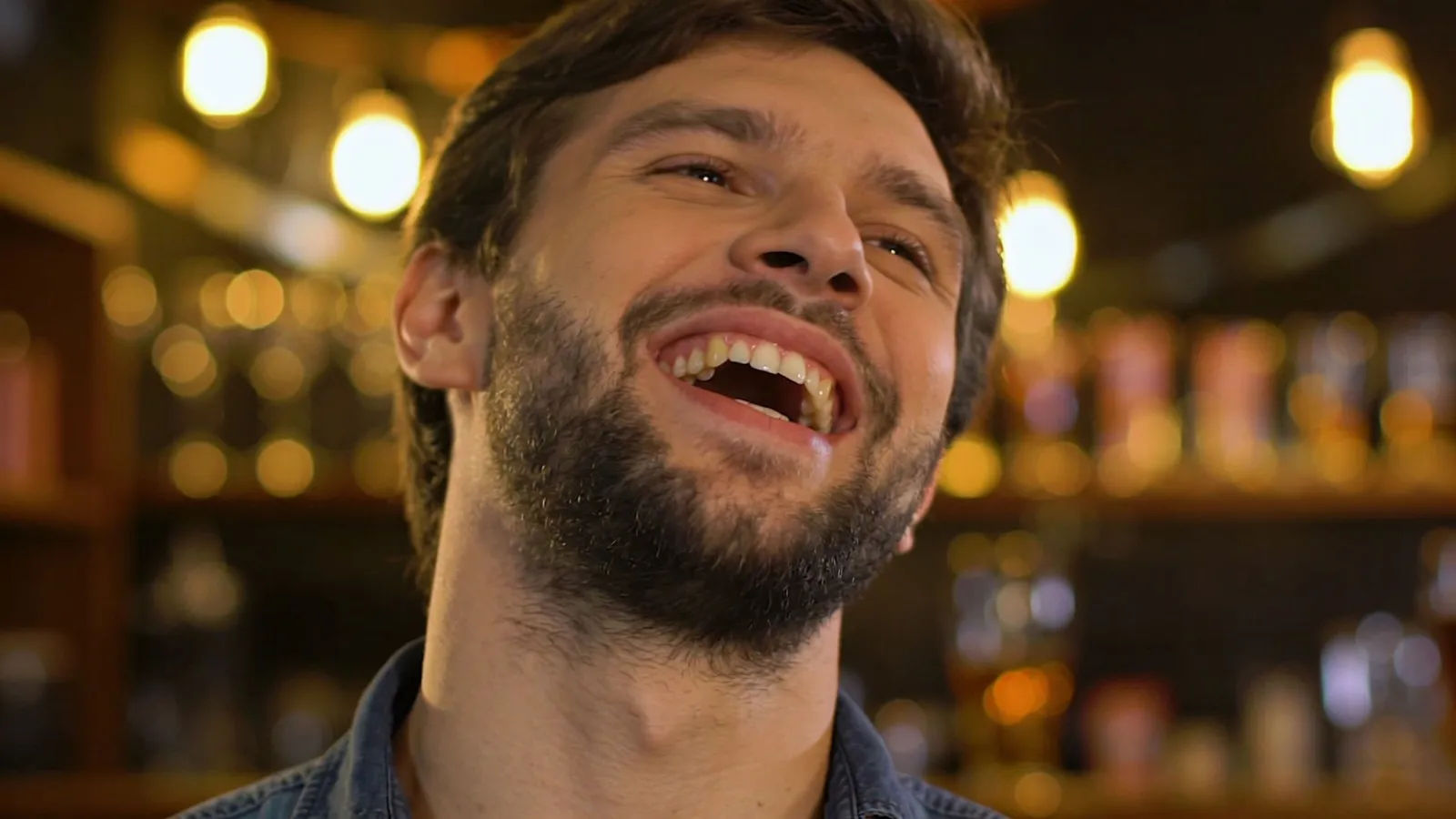 Expressive person mid-laugh in cozy golden light