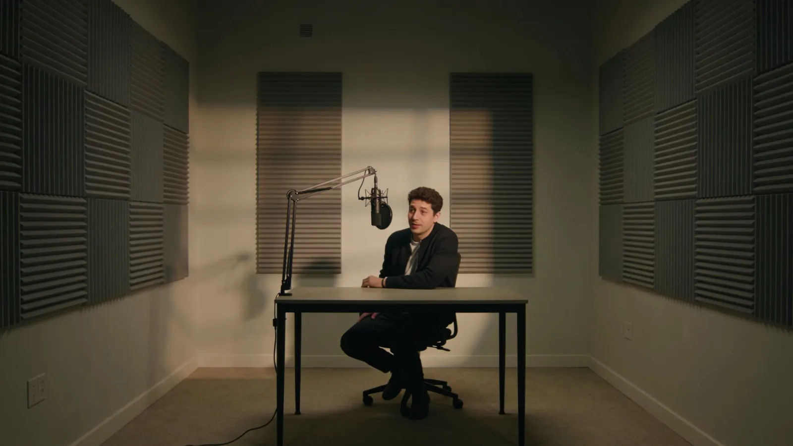 Lone host at a podcast studio desk