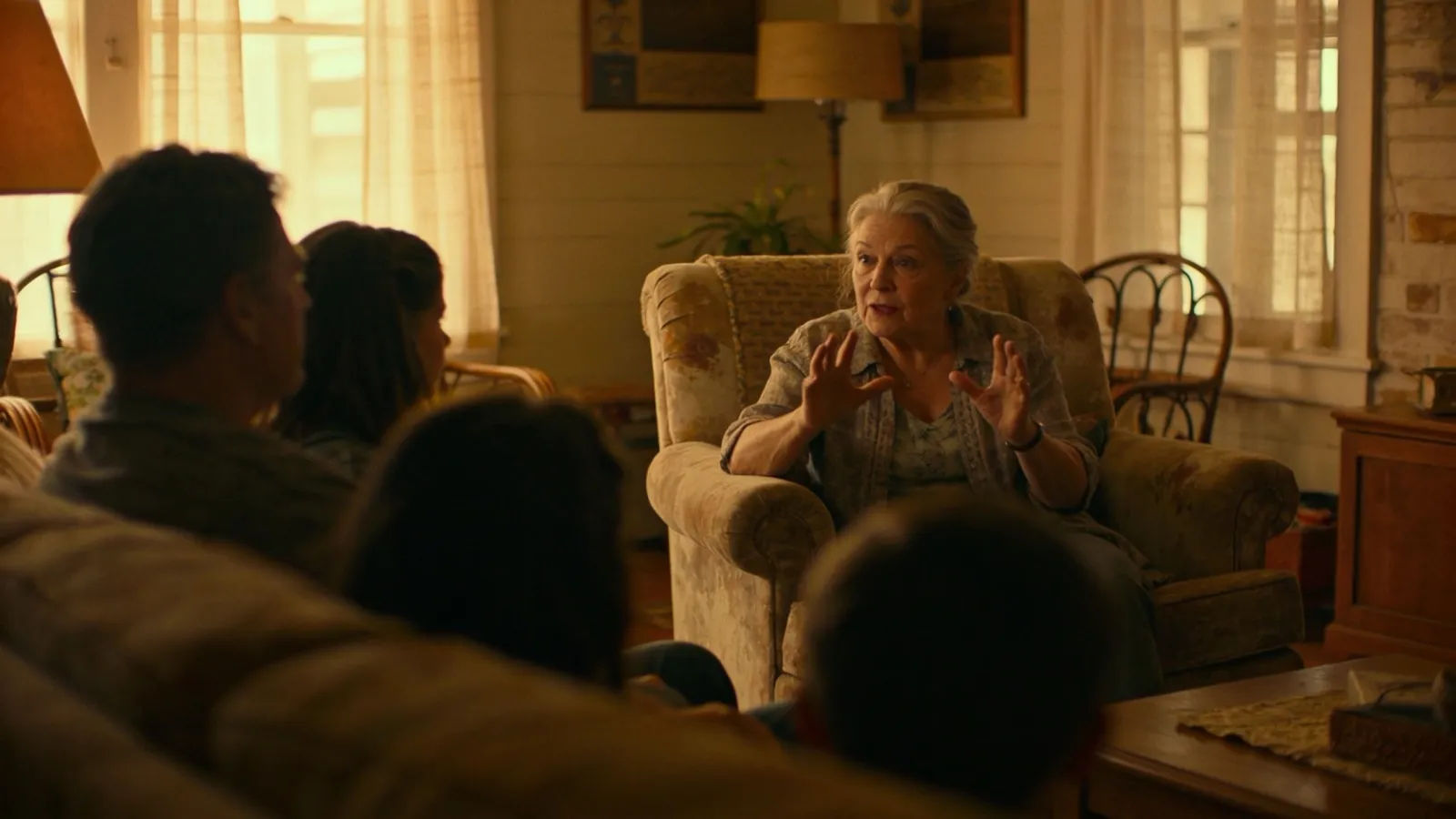 Older woman telling story to family