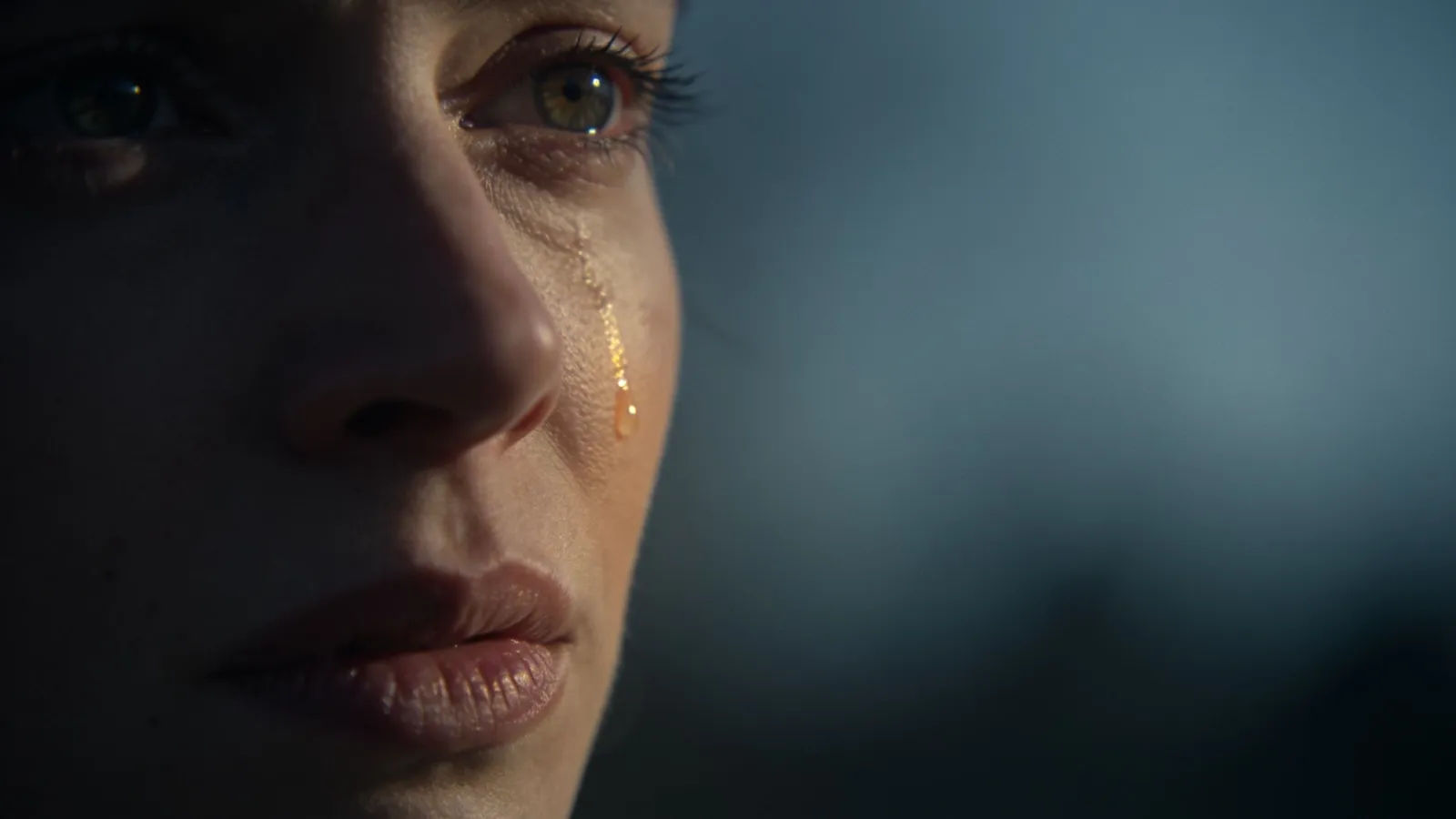 Tearful emotional portrait in dramatic cool light