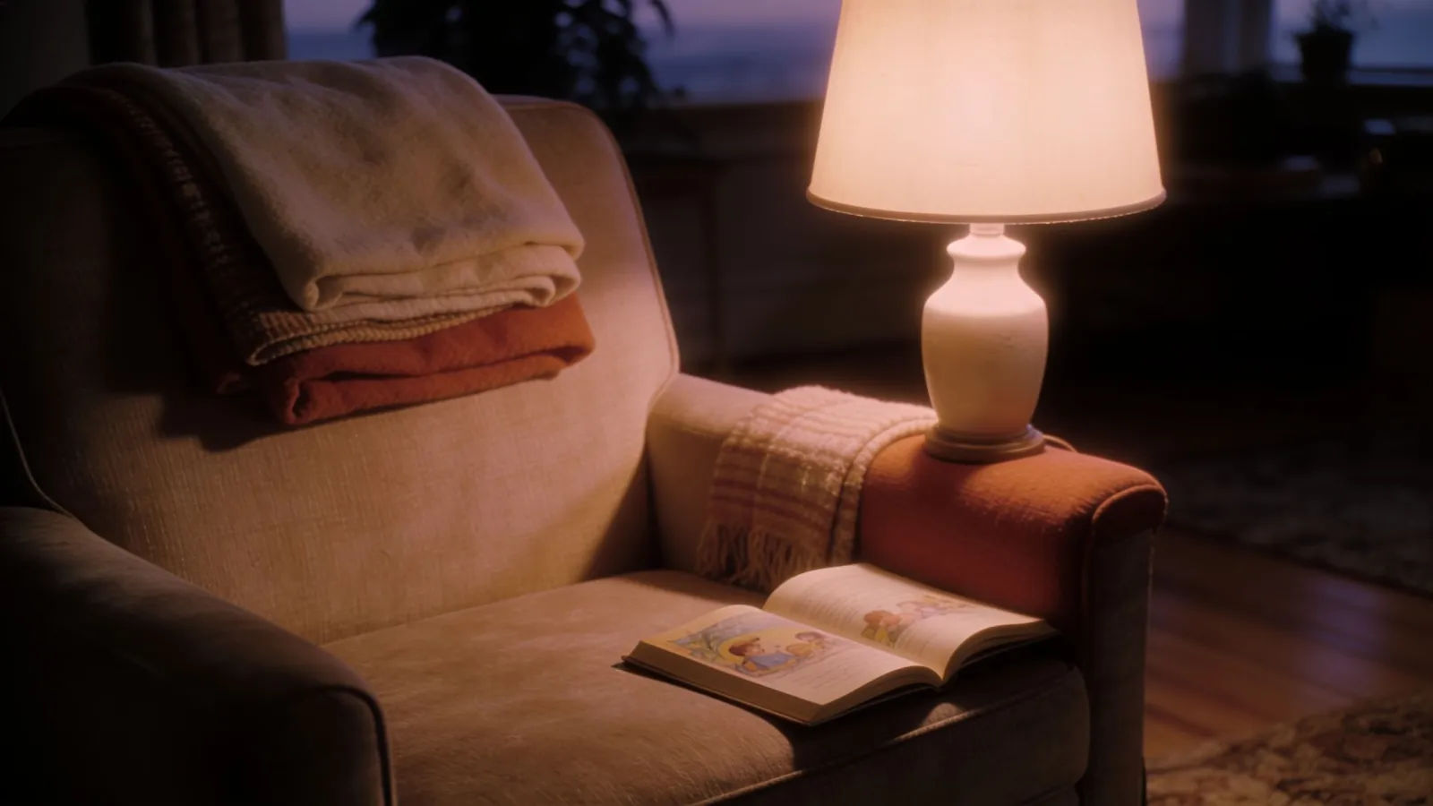 Cozy living room at dusk with lamp and storybook