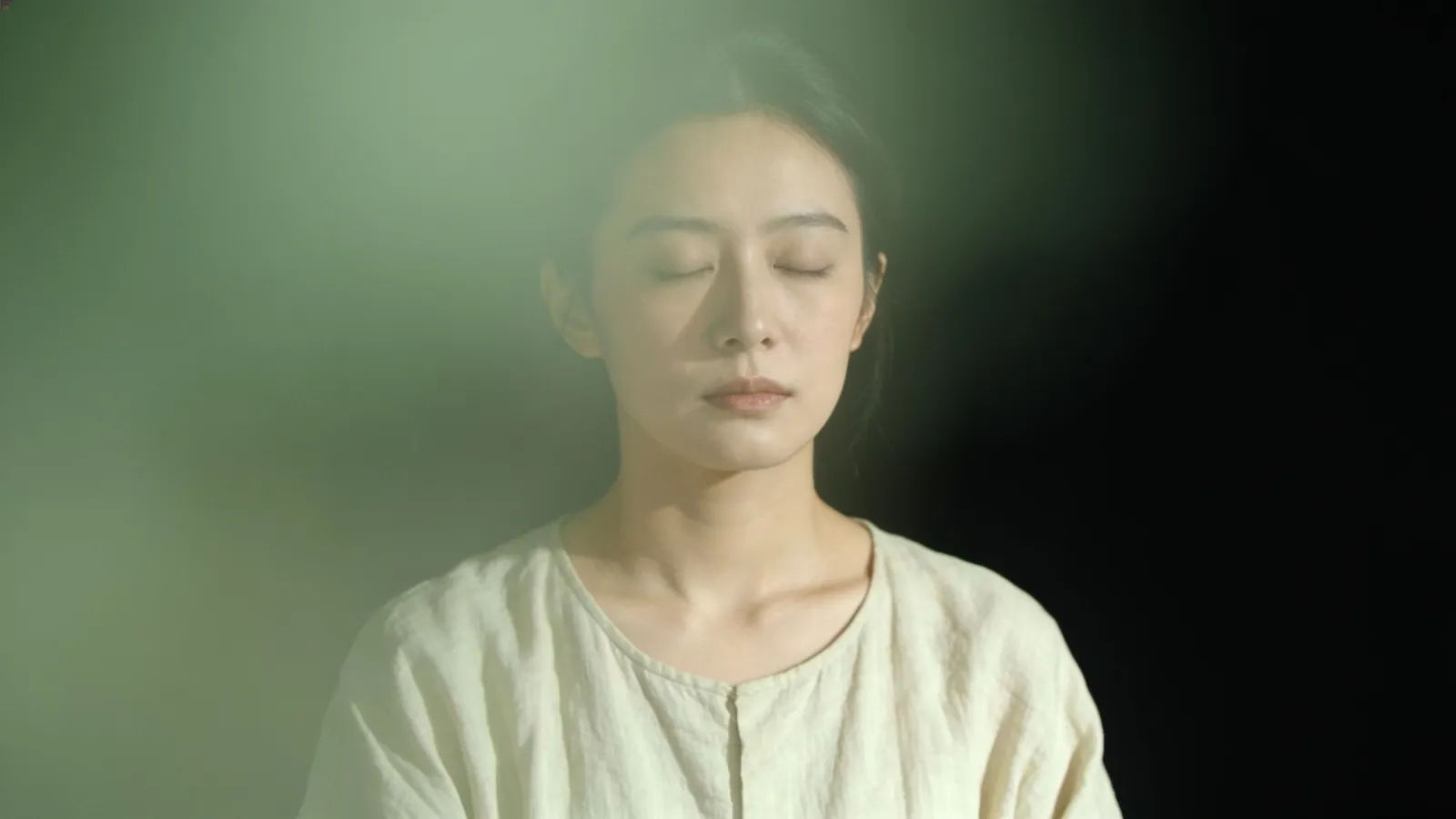 Serene person with eyes closed in calm light