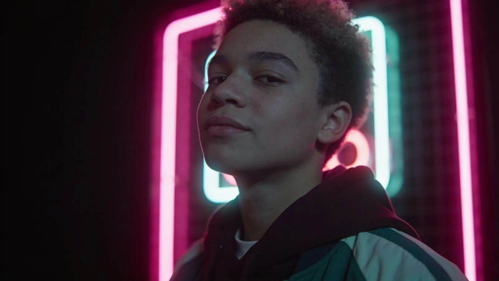 Confident young person in streetwear under neon light