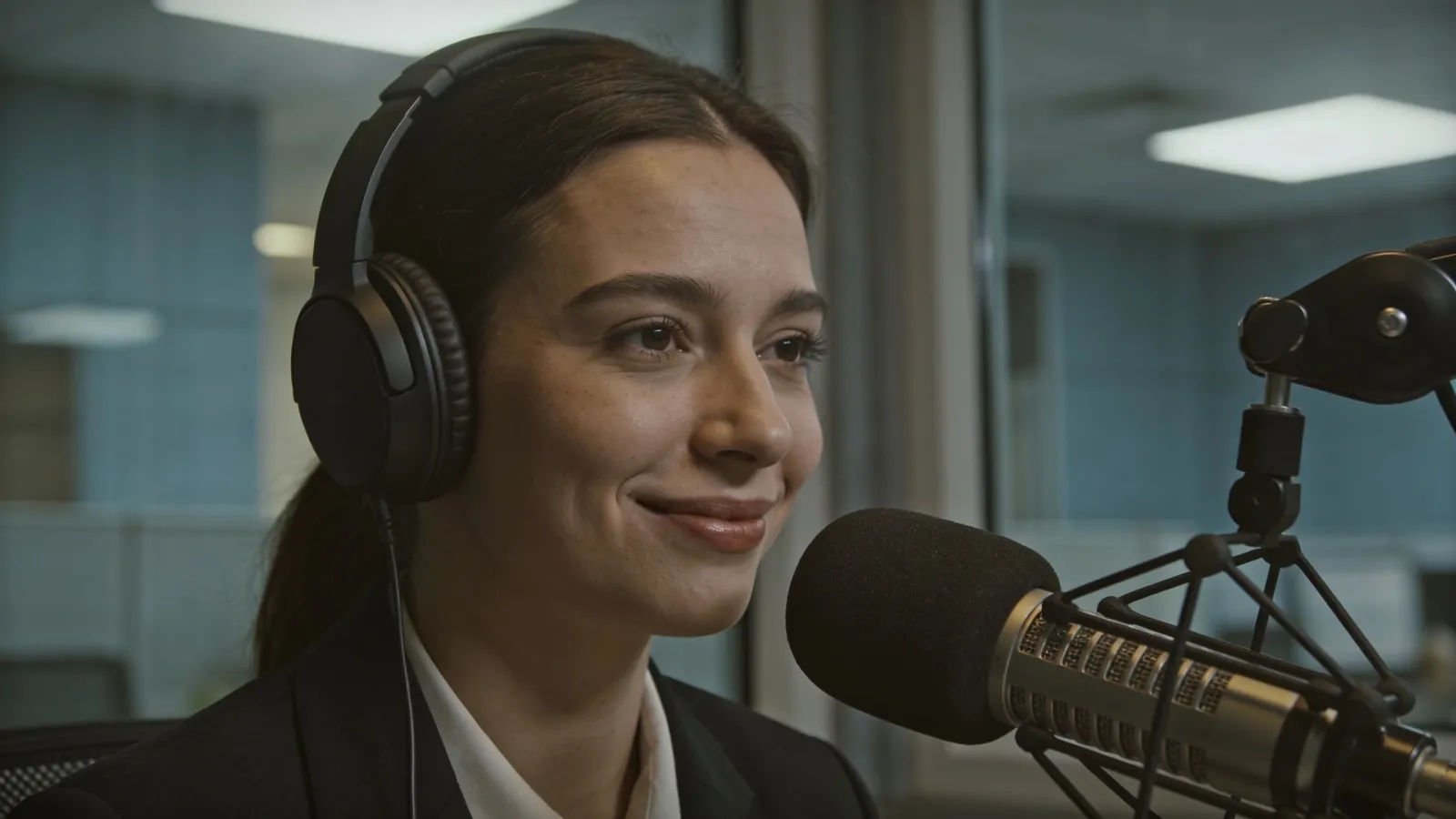 Composed professional in headset at a studio microphone