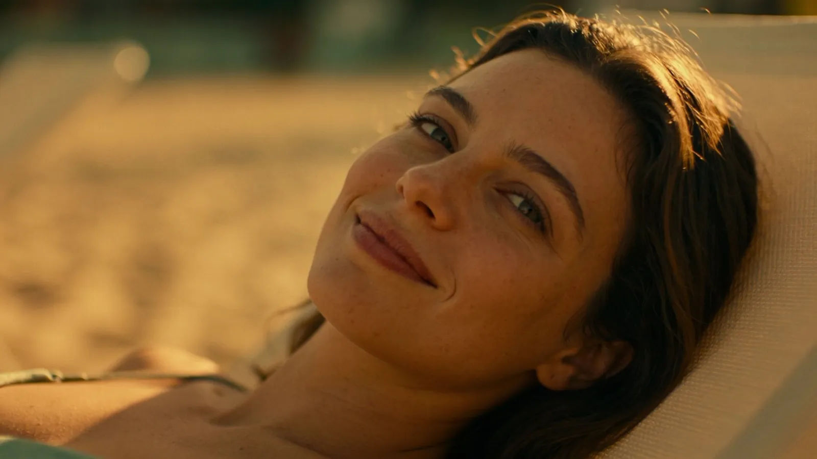 Relaxed person lounging with calm smile in golden light
