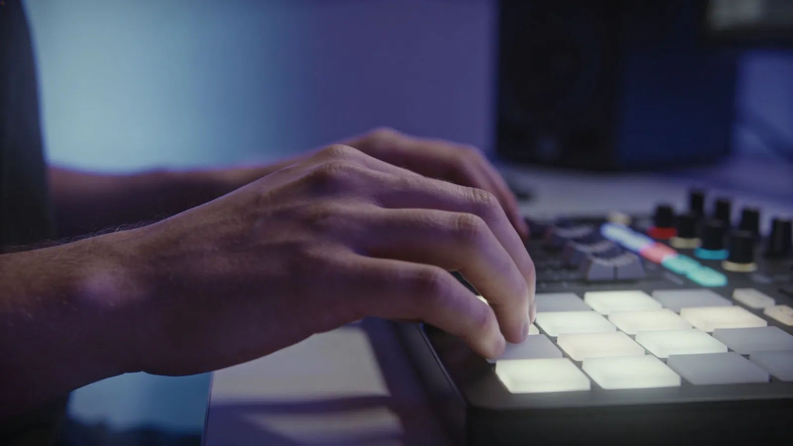 Hands resting at a softly lit calm audio console