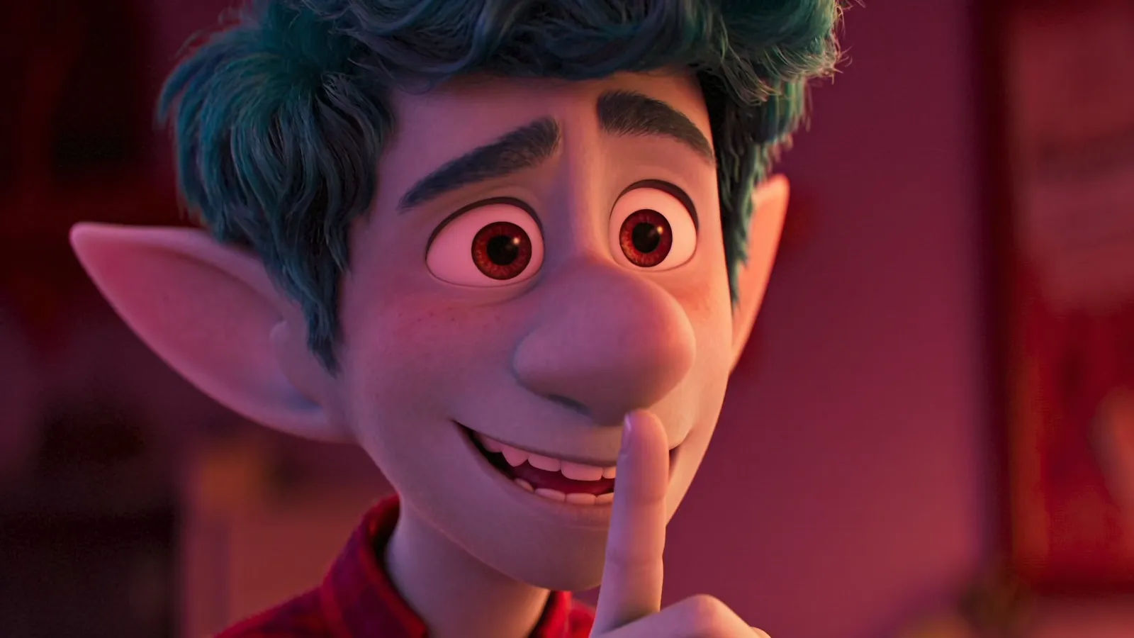 Gleeful prankster smirking with finger to lips