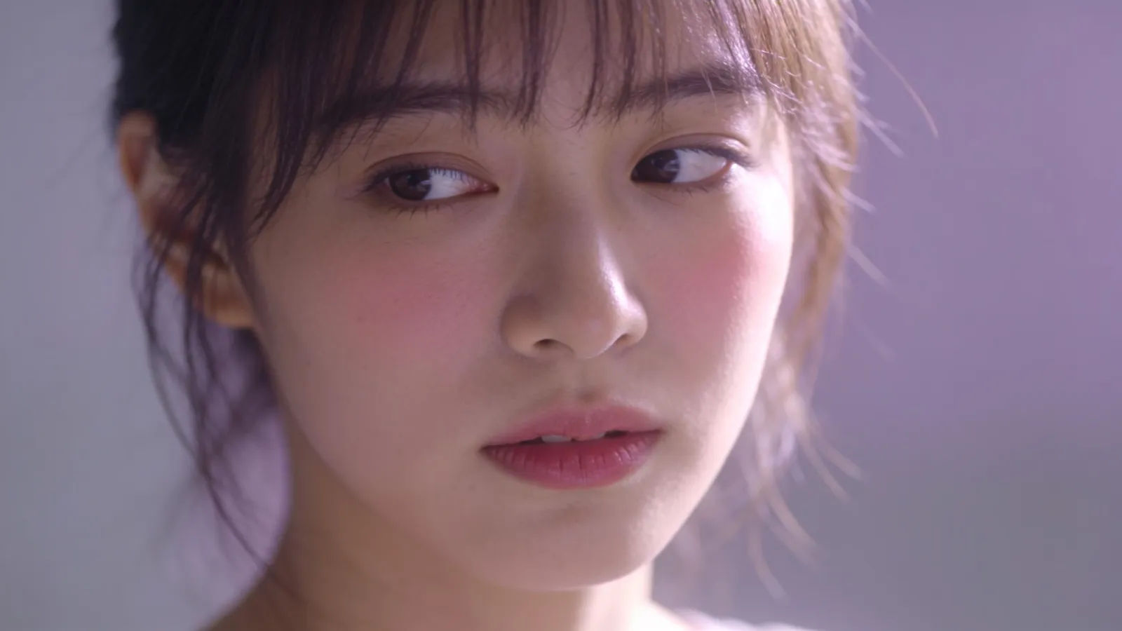 Soft-spoken shy person glancing gently away