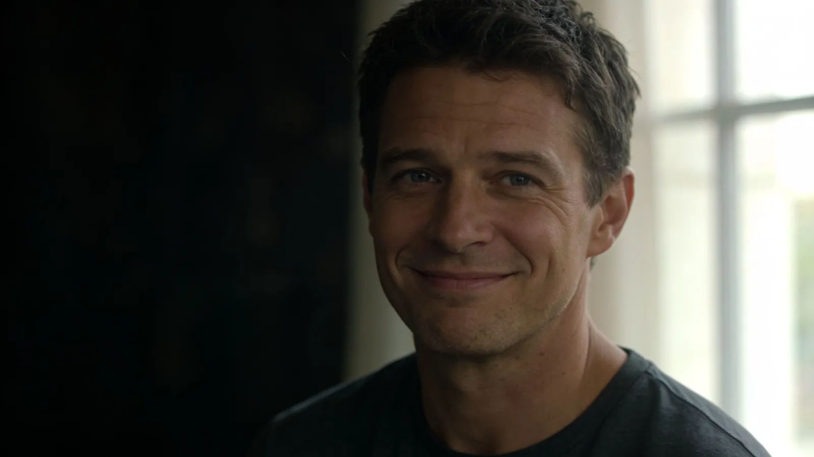 Natural everyday person smiling warmly in cinematic portrait