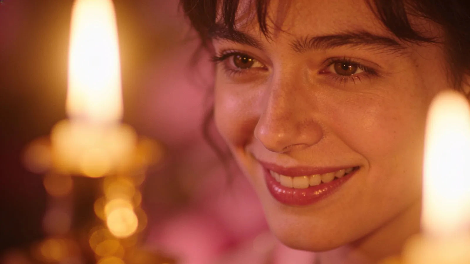 Warm candlelit portrait with a soft loving smile
