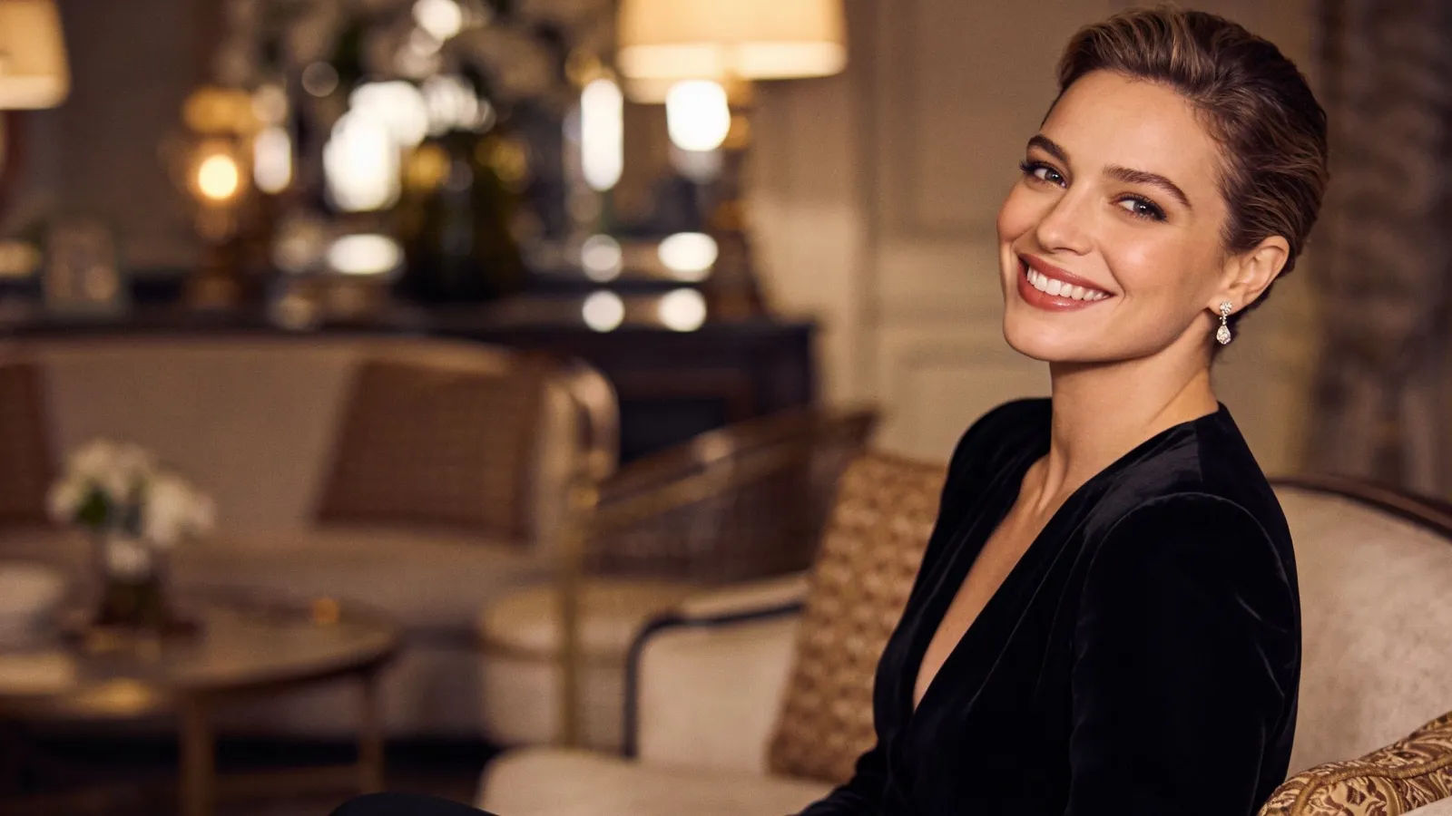Confident elegantly dressed figure with playful knowing smile
