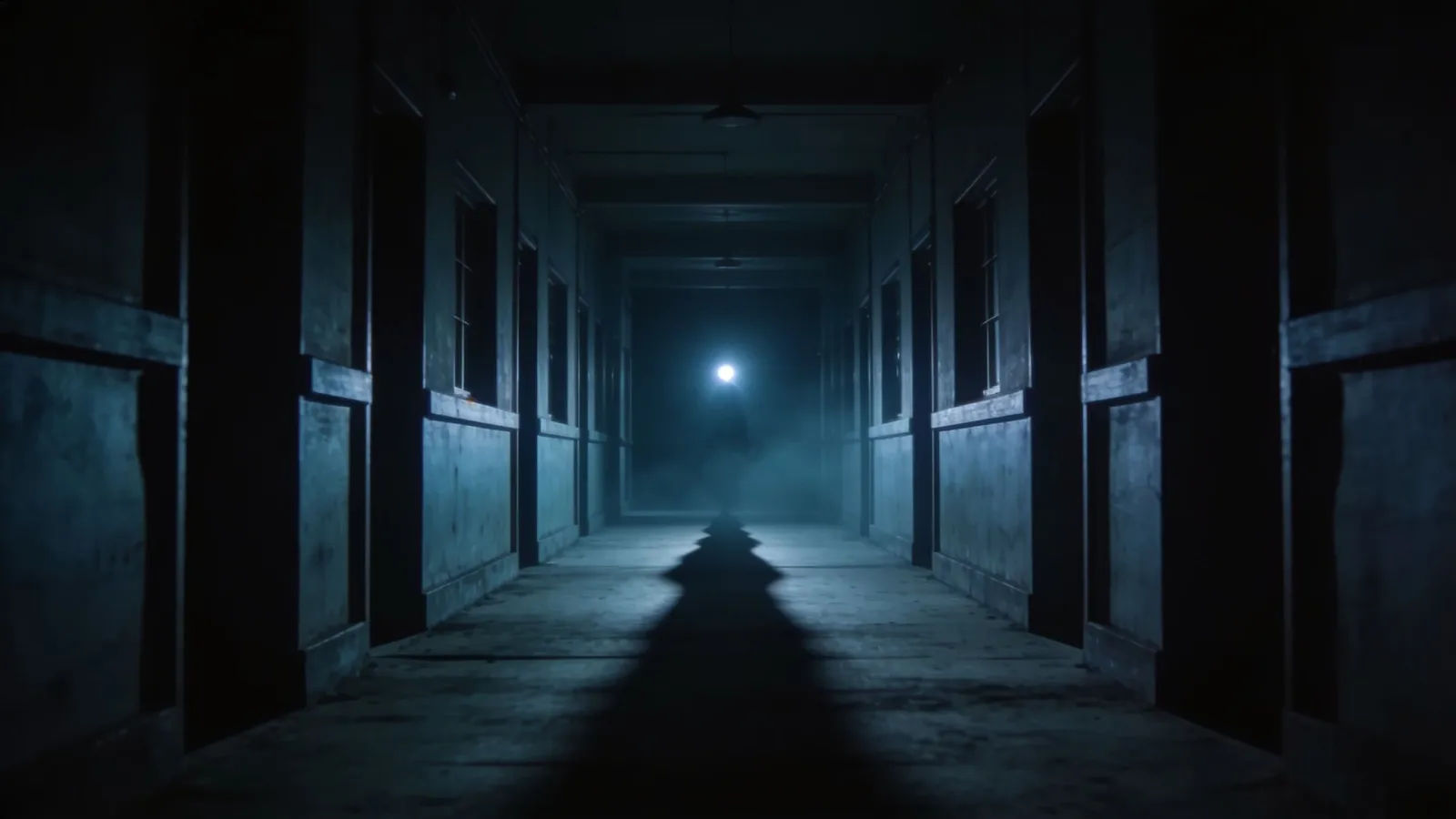 Dim empty corridor with flickering distant light
