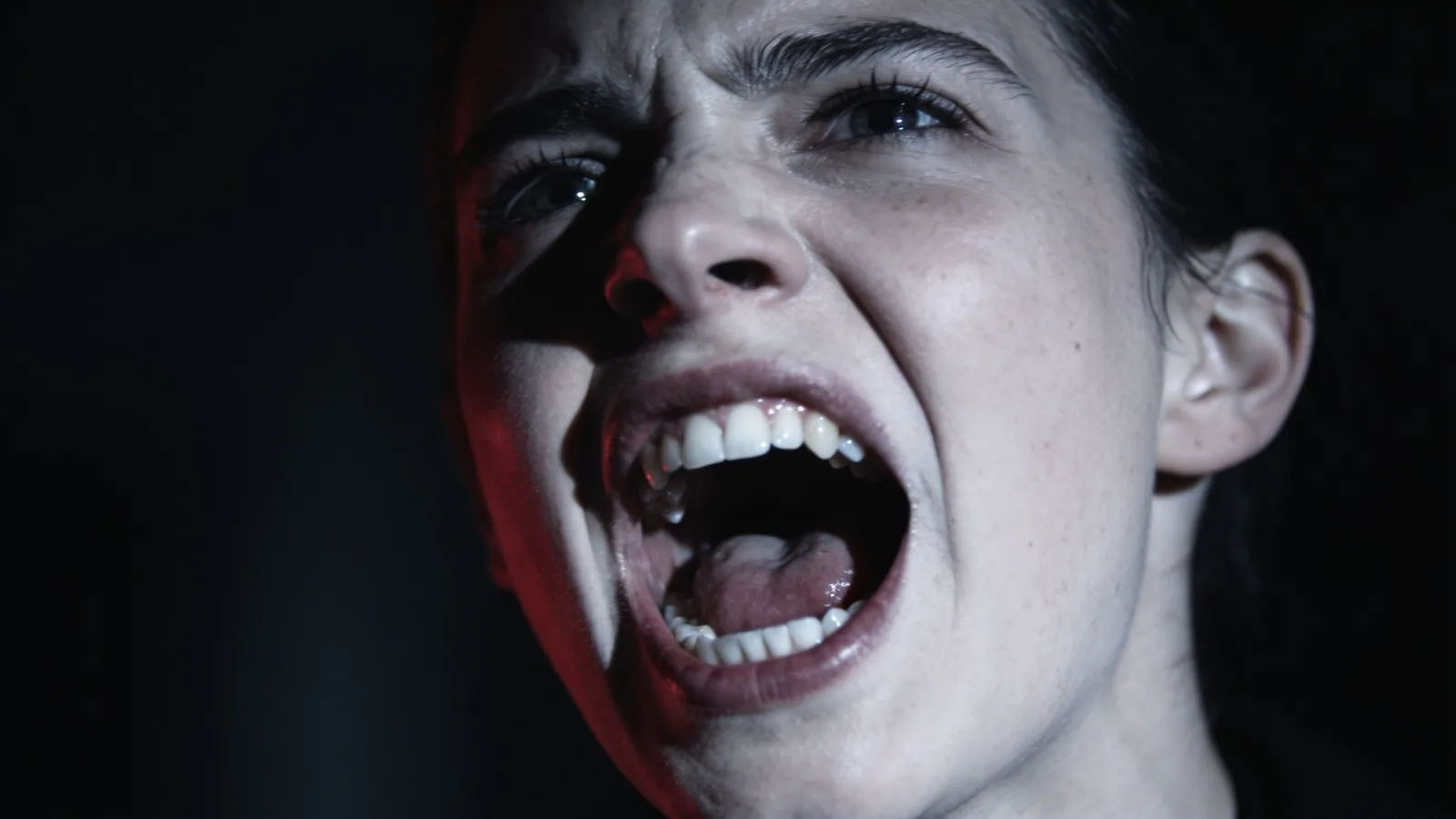 Intense figure mid-scream, dramatic shadow, no gore