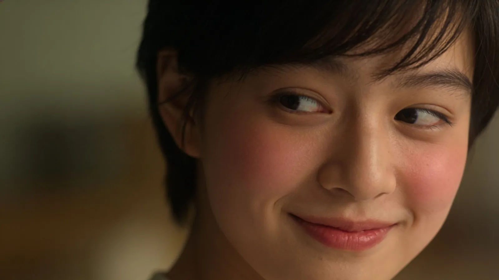 Shy bashful young person glancing away, timid smile