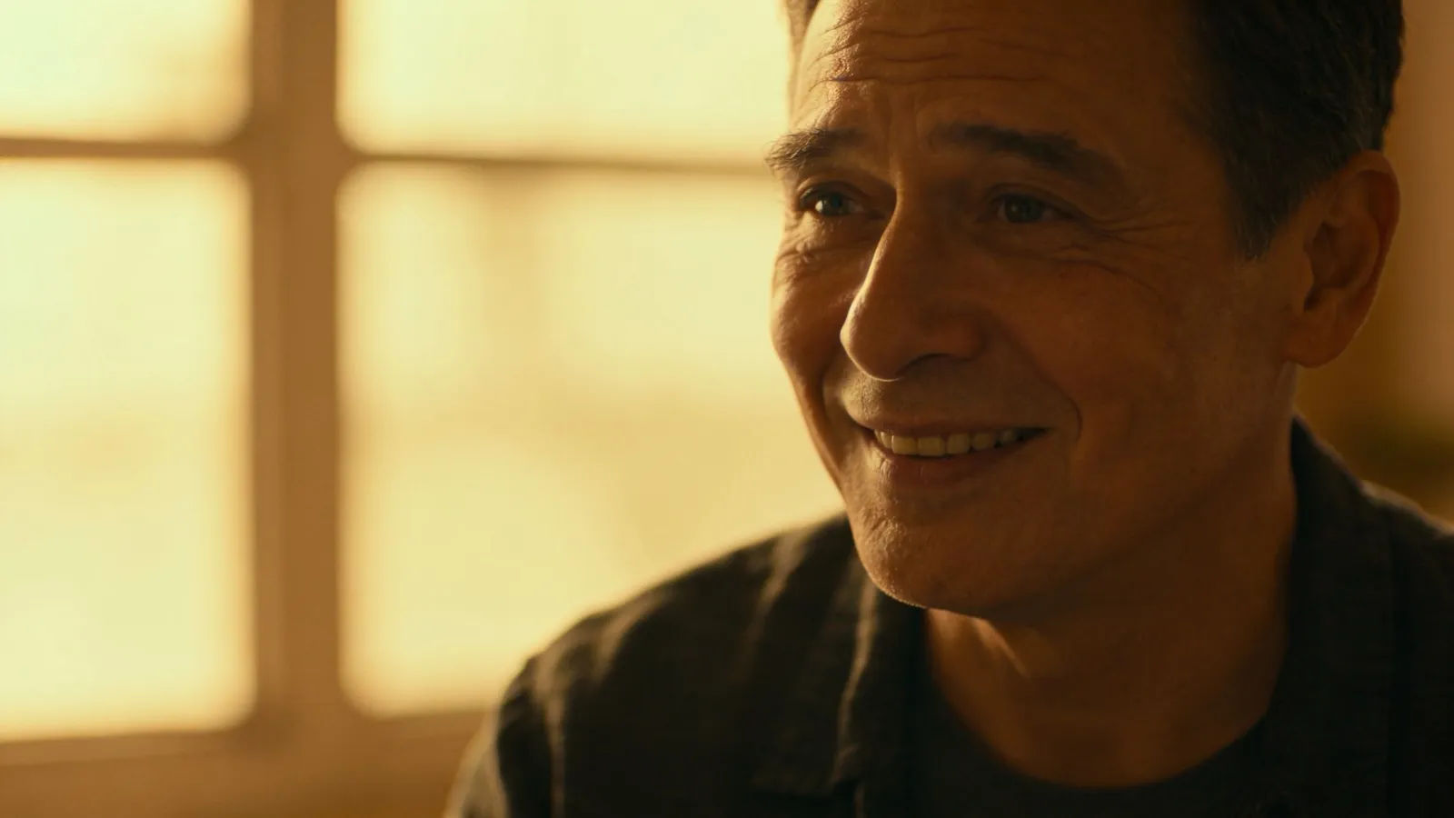 Sincere warm person with heartfelt expression in golden light