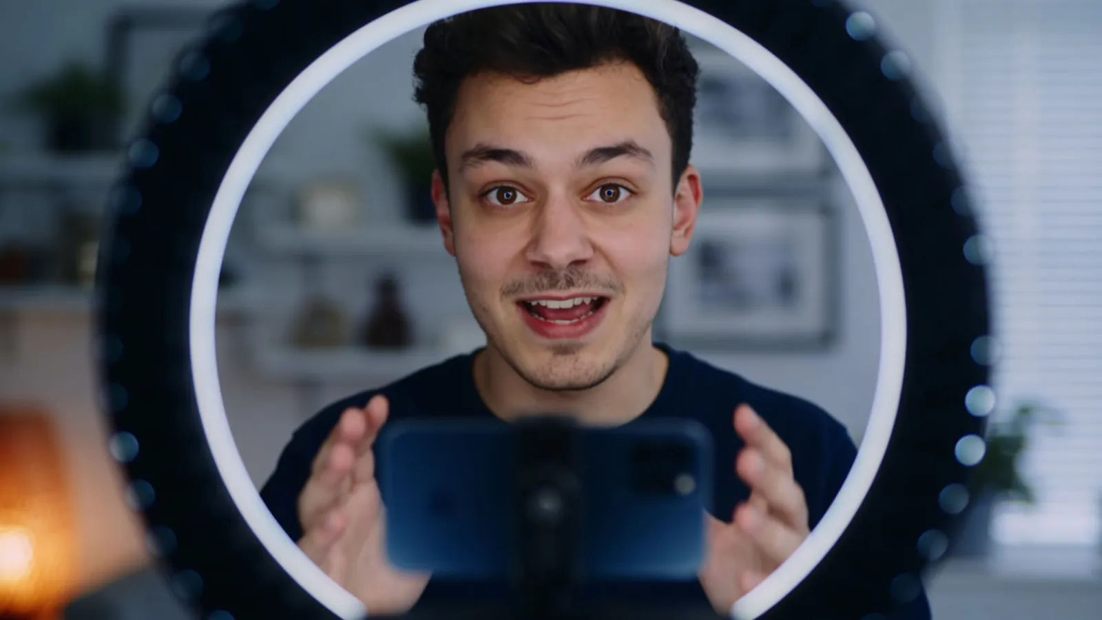 Upbeat young content creator speaking brightly to camera