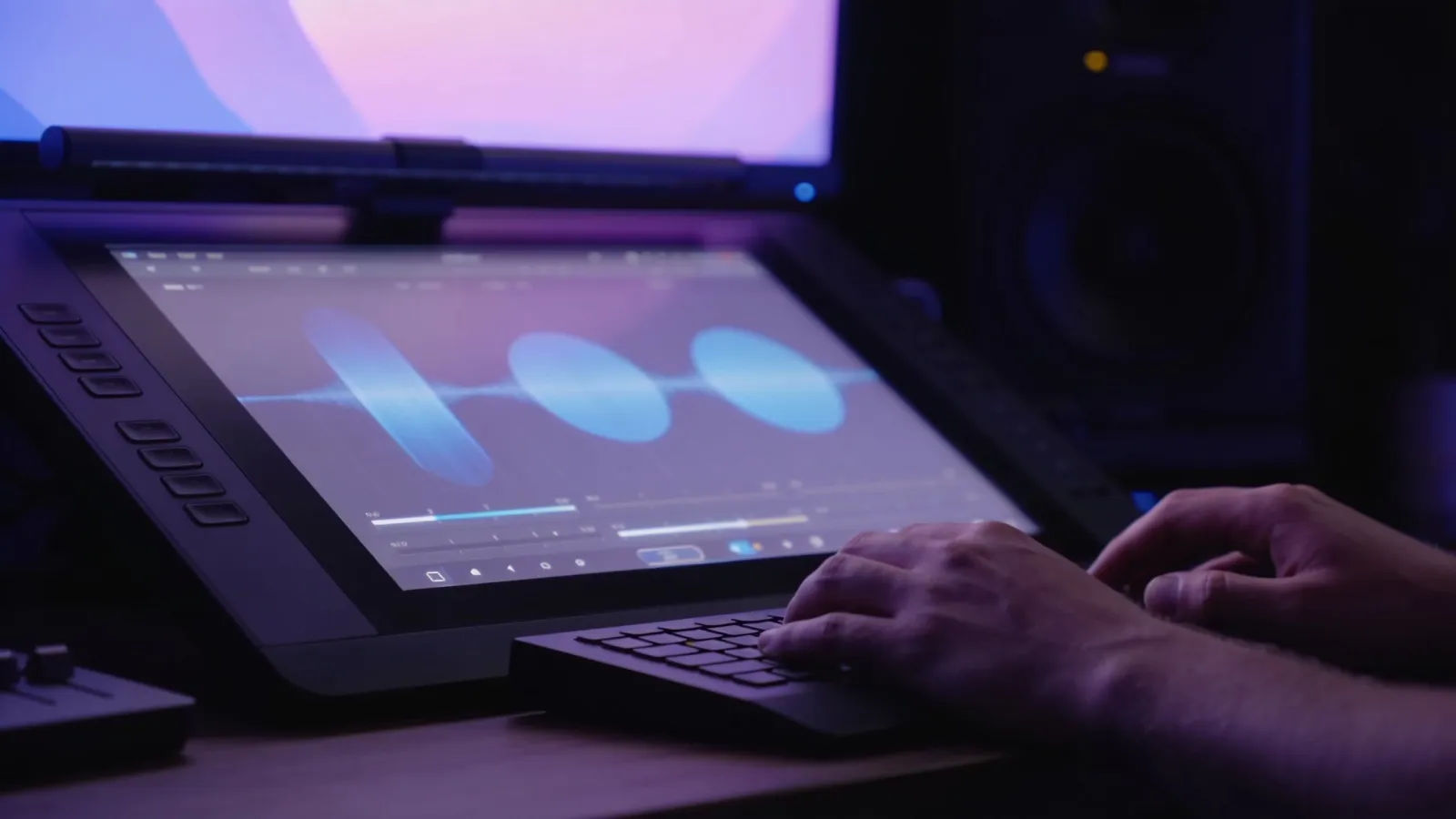 Hands at dim ambient console with gentle audio glow