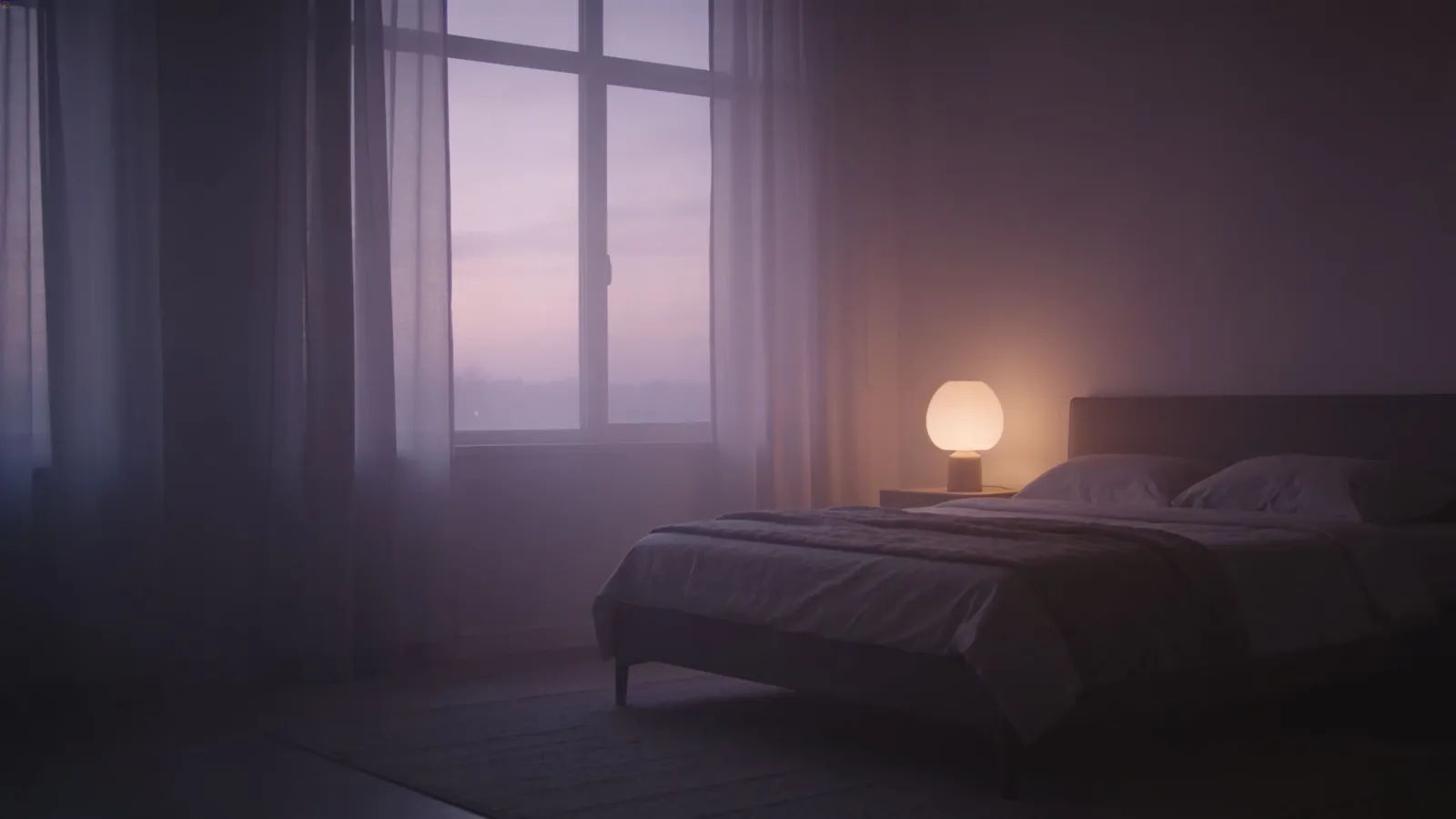 Peaceful dim bedroom at dusk with soft lamp glow