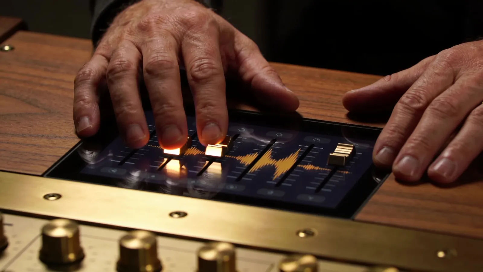Hands on wood-and-brass console with abstract audio UI