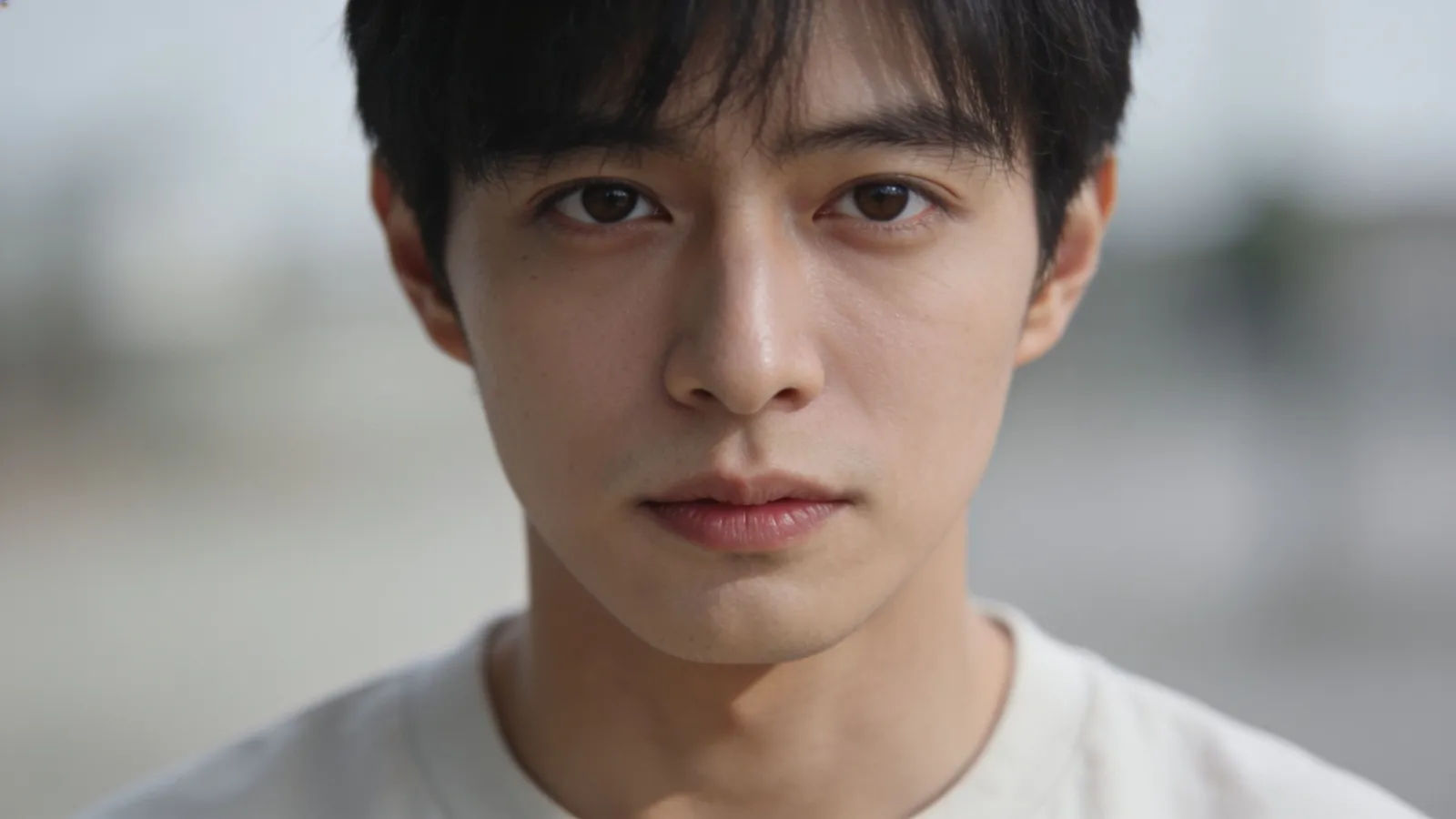Calm clear-eyed person with a neutral direct expression
