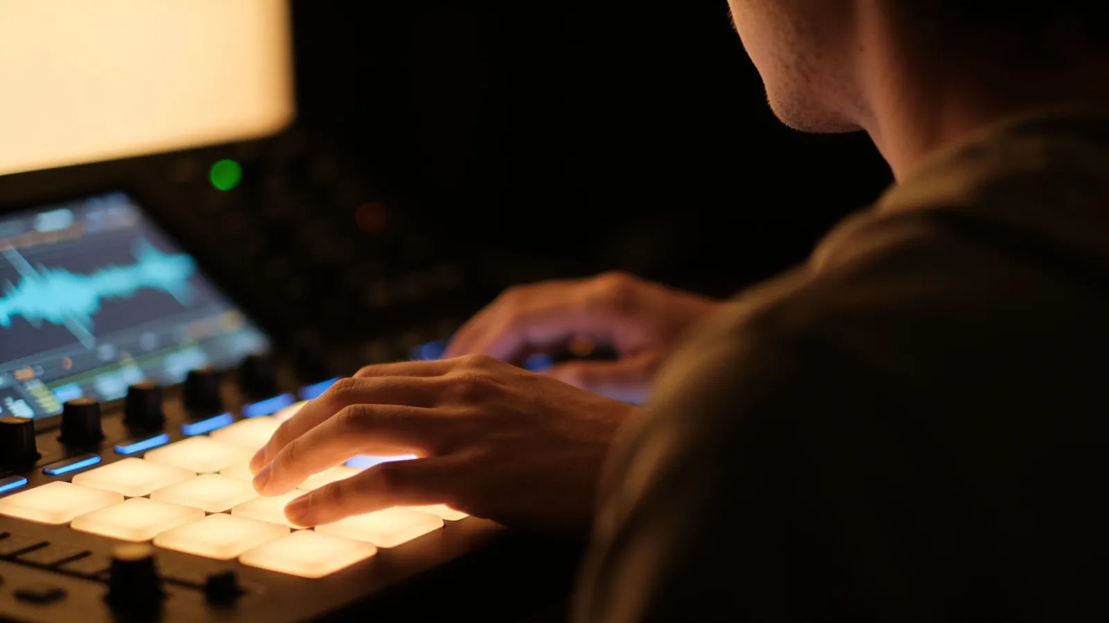 Hands resting on a soft-lit console