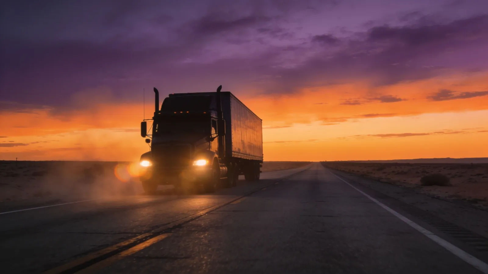 Big rig on an open highway at dusk