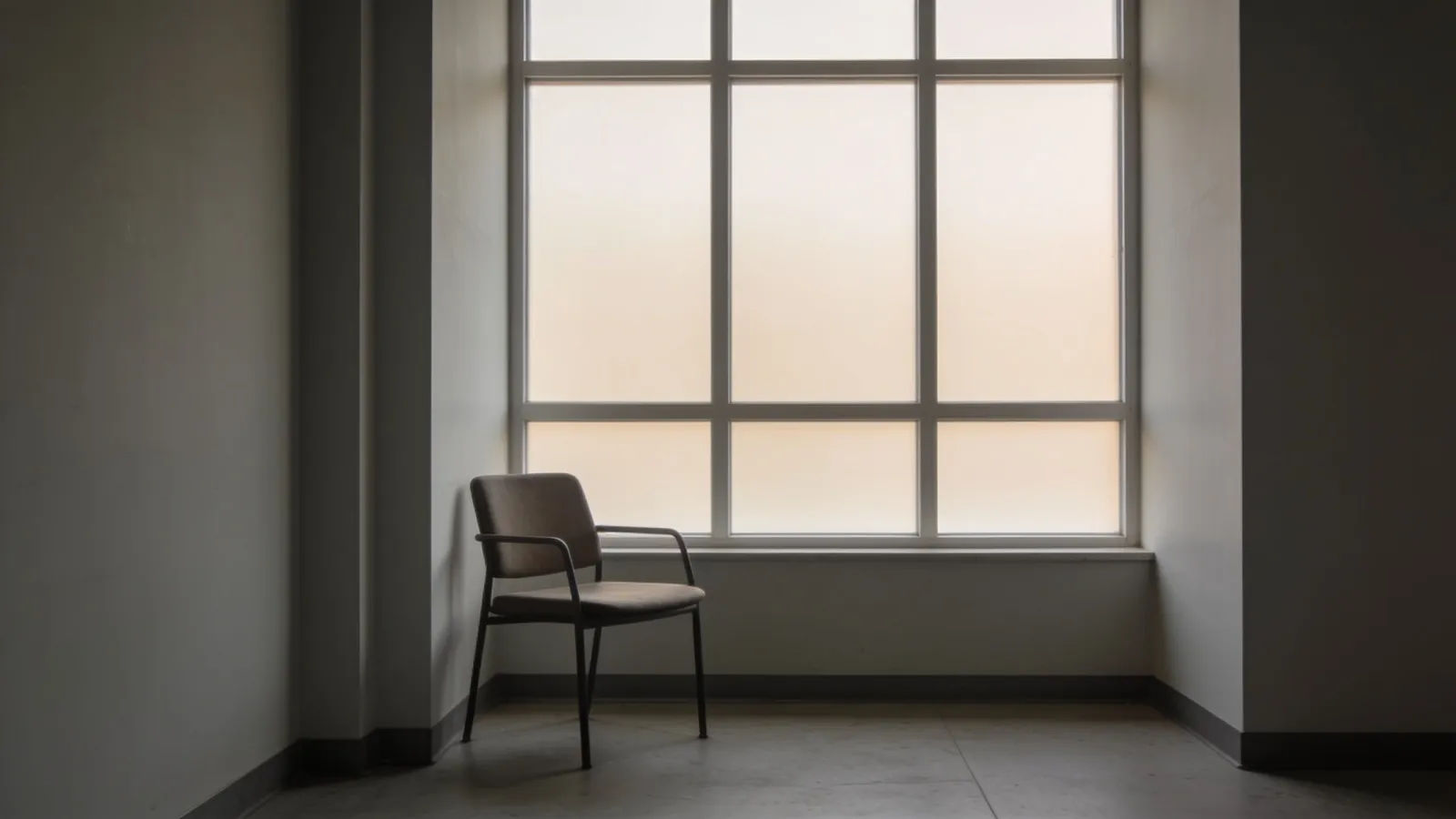 Minimalist documentary interior with chair by window