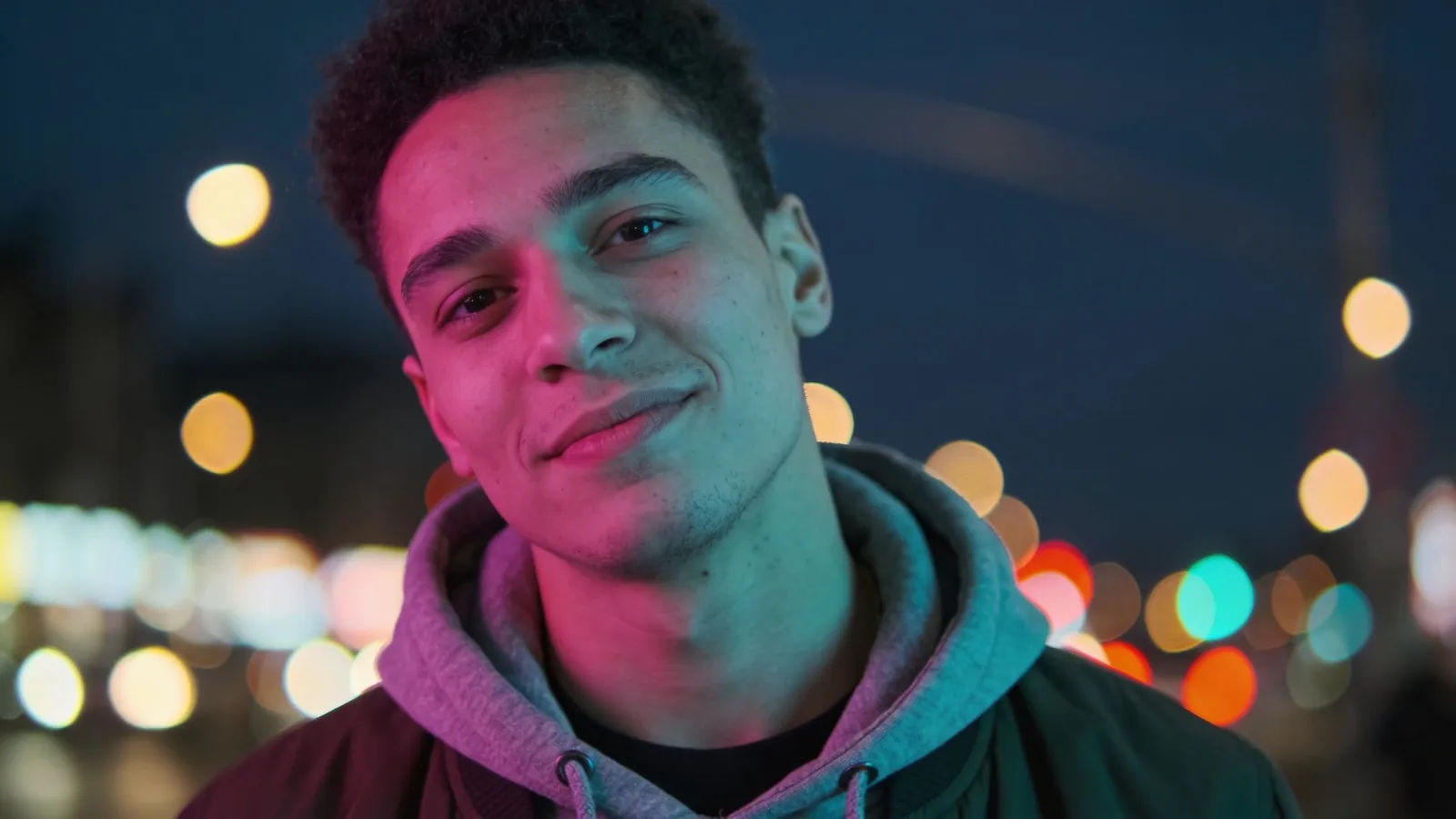 Relaxed city person with neon street bokeh