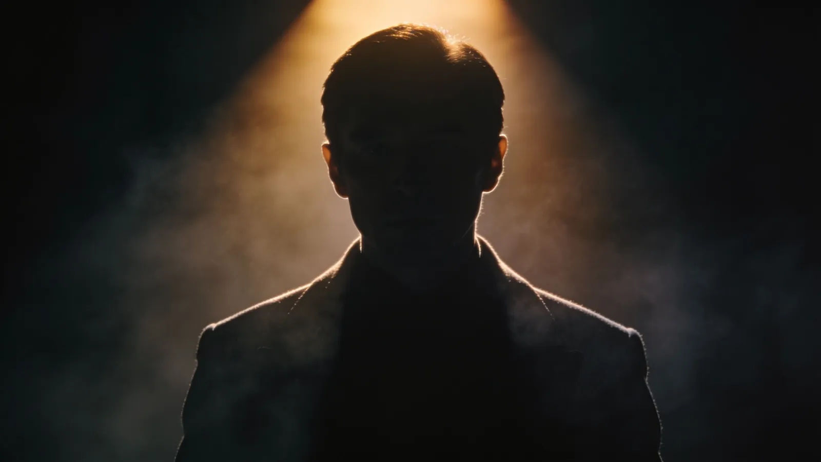 Silhouetted narrator figure backlit in a dark studio