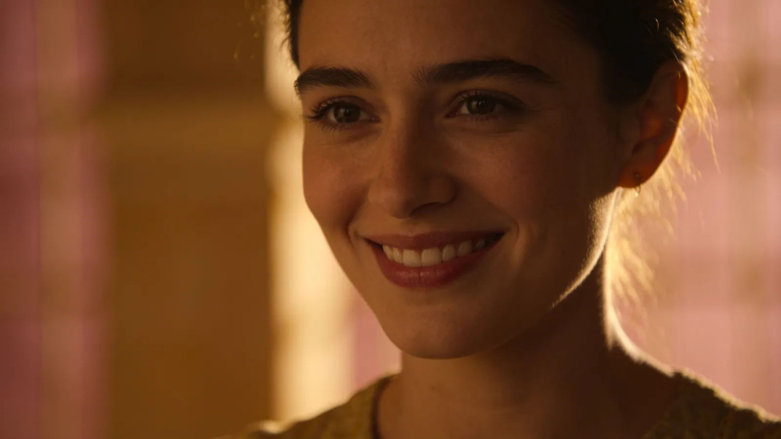 Gentle narrator with serene smile in soft golden light