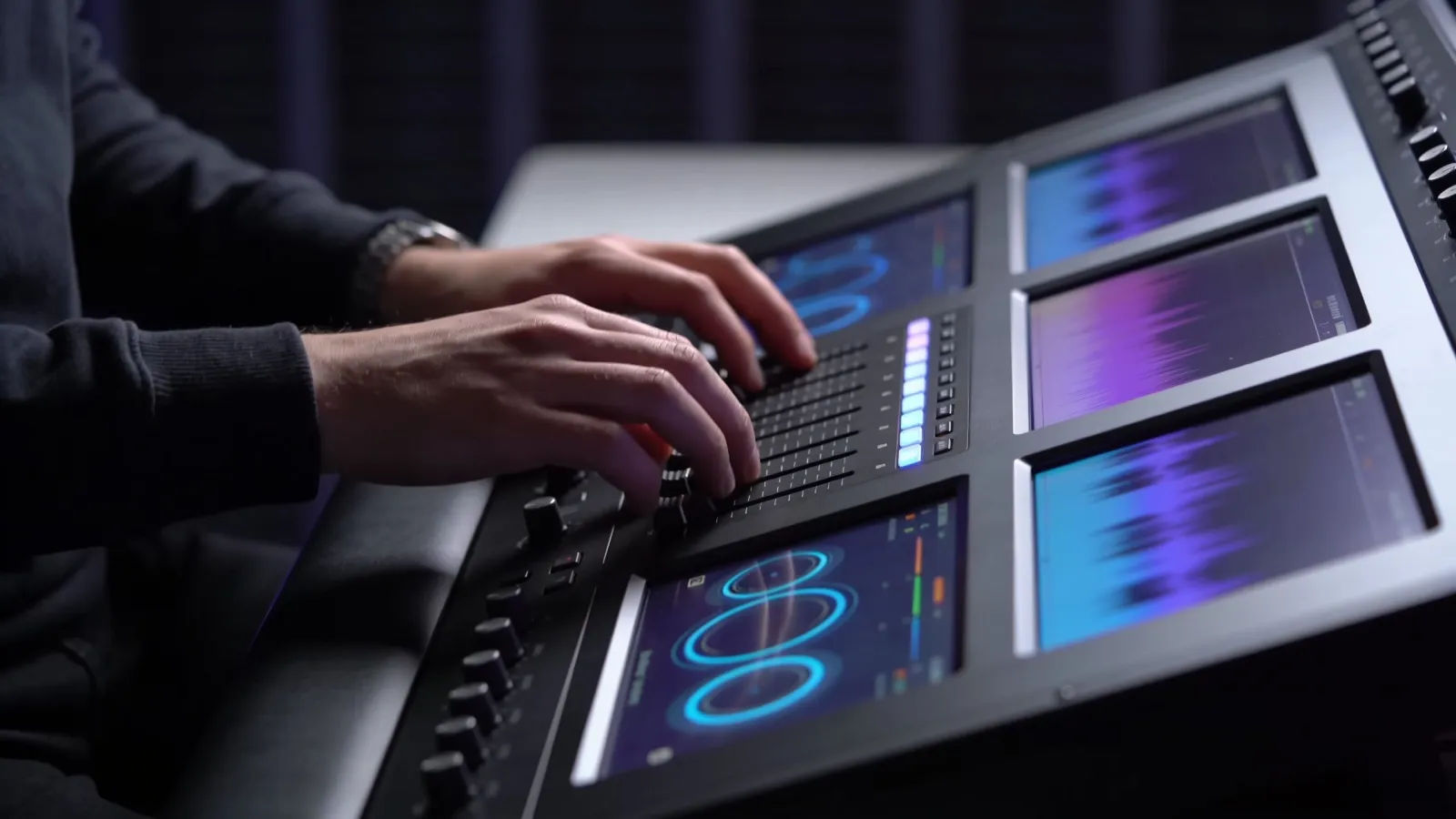 Hands at sleek console with cool glow