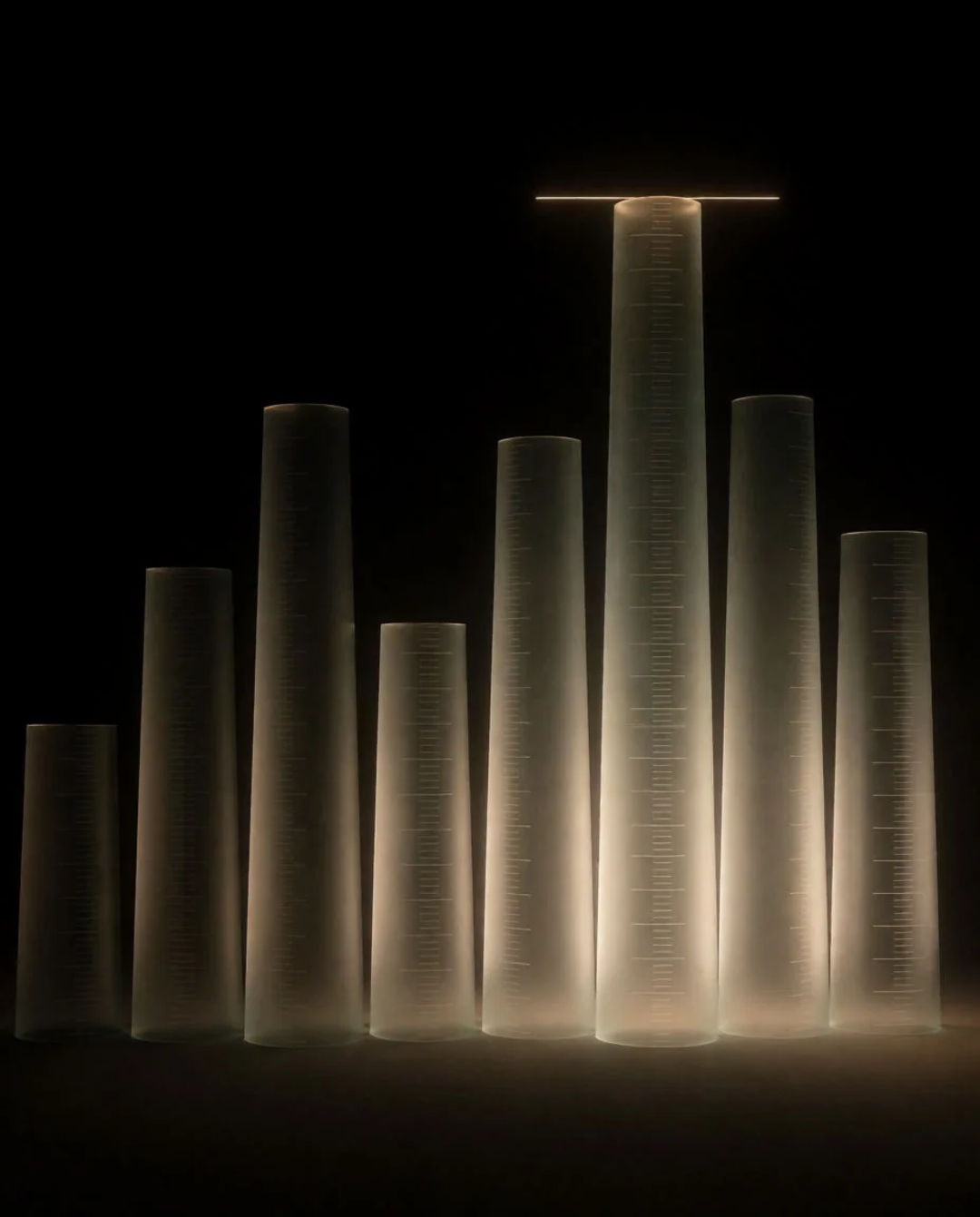 Glass columns of measured heights with a glowing limit line