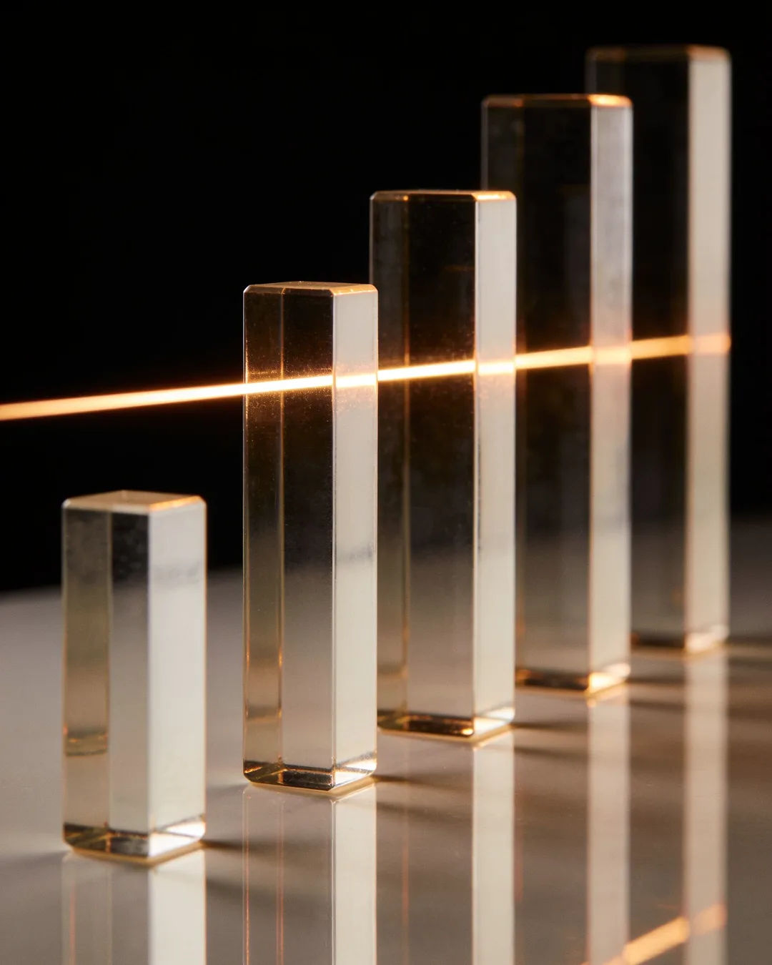 Glass columns of different heights with a glowing limit line