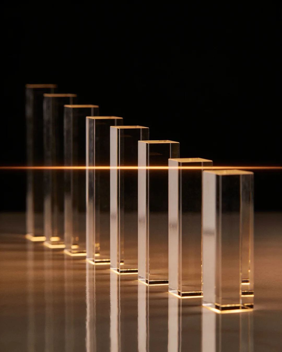 Glass columns of different heights with a glowing limit line