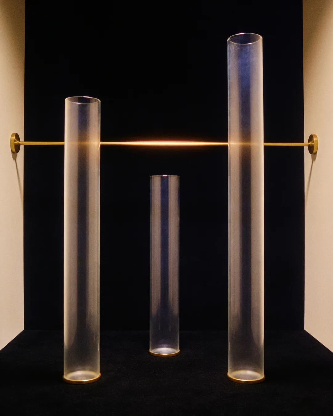 Glass columns of different heights with a glowing limit line