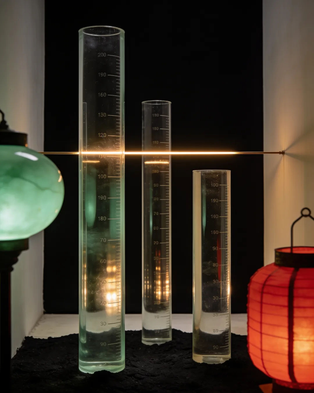 Glass columns of different heights with a glowing limit line